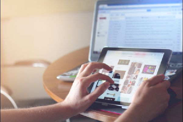 image of computer and lap top and person making selections