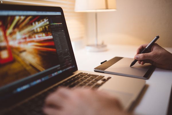 image of a man working on a computer designing a website